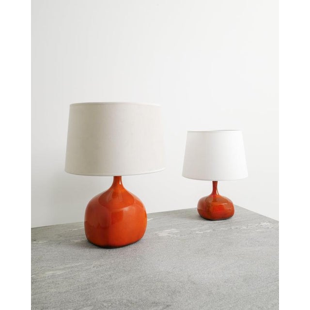 A rare pair of french mid century red ceramic table lamps by jacques & dani ruelland produced in their own atelier in...