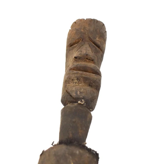 The Suku Figural Post originates from the Suku people of Tanzania, serving as a significant cultural artifact. Carved from...