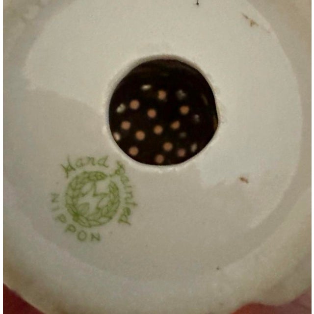 Charming antique porcelain hatpin holder featuring delicate hand-painted floral decoration and classic period styling....