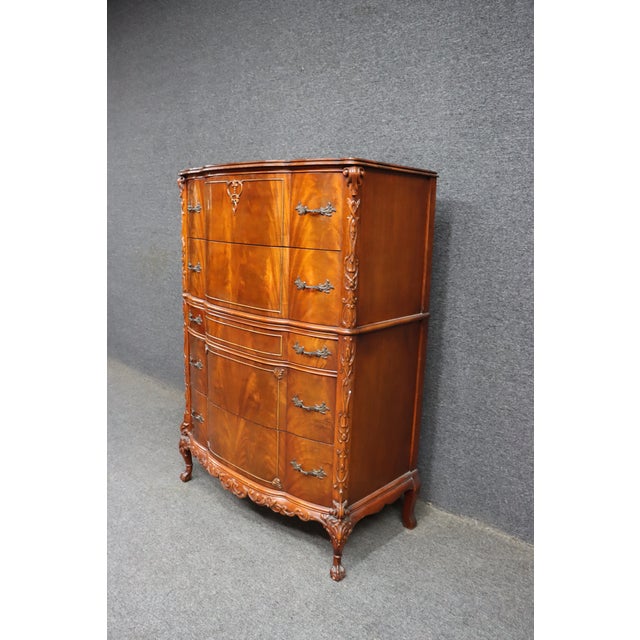 Mid 20th century mahogany gentleman’s chest in the Chippendale style. Features a serpentine front with flame mahogany...
