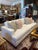 A contemporary sofa with track arms and an oak base. Memory-Down fill cushions upholstered in a crisp white woven fabric....