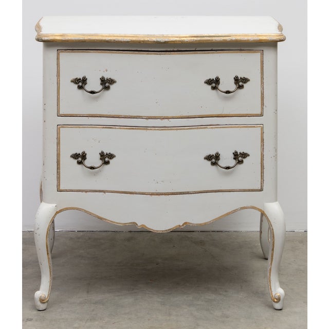 French inspired nightstand reproduced by Eloquence furniture. Painted finish with beautiful distressed gold highlights