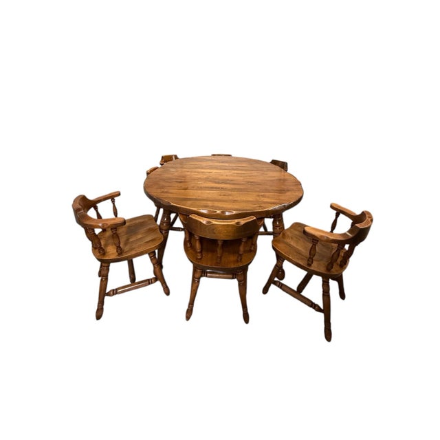Beautiful vintage 1970s Early American / Colonial Revival solid pine dining set, complete with eight matching chairs and...