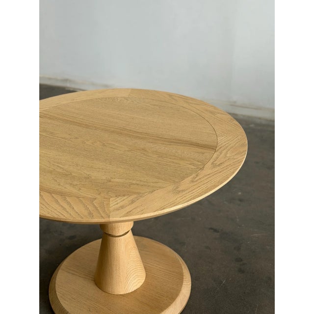 W42 H30.5 KC28 Our pedestal base table, the Forma features a sculptural architectural form through a hand turned central...