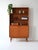 Teak bookcase composed of closed compartments and open shelving. Inside the space is divided by shelves. The lower part...