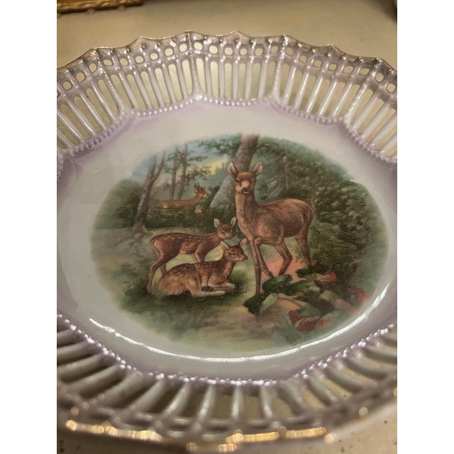 Beautiful German bowl with a deer family scene on the surface. The reticulated edges add to its uniqueness along with its...