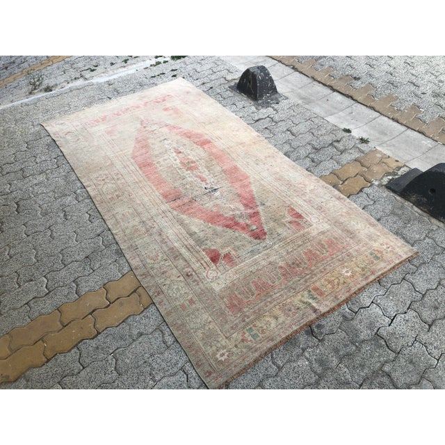 This is a vintage Turkish Oushak rug from the 1960s. The piece was hand-knotted.