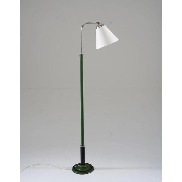 132-180 Lovely early functionalistic floor lamp manufactured in Sweden, 1930s. The lamp consists of a green and black iron...
