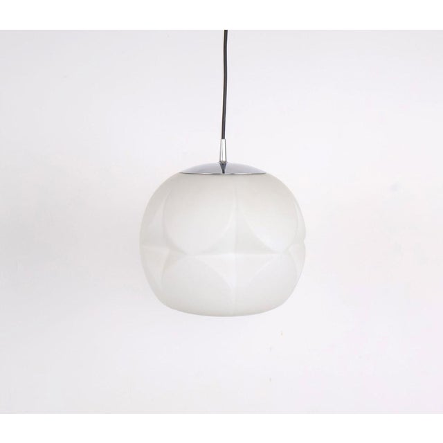 Vintage pendant lamp by Peill & Putzler from the 1960s. The lamp is made of high-quality white opaline glass and has a...