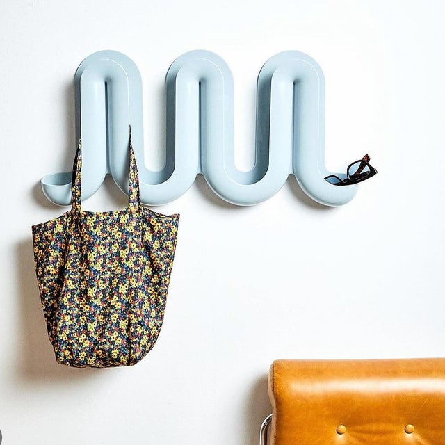 Transform your home’s entrance into a fun and multi-functional space with the whimsical wave-like Heller® Swell™ wall-...