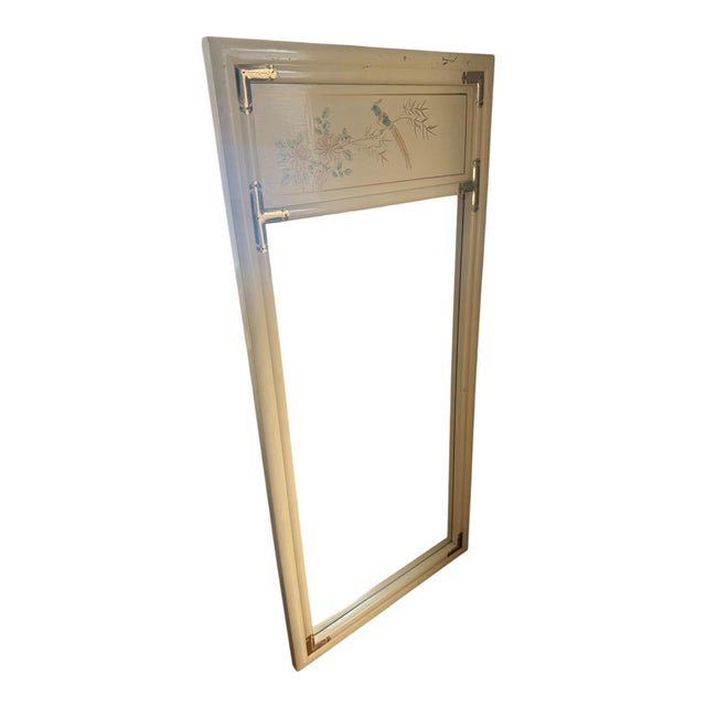 Vintage chinoiserie wall mirror featuring a cream lacquered frame with hand-painted bird and floral detailing along the...