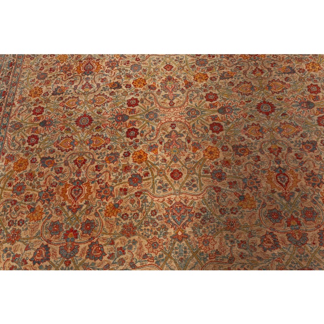 A hand-knotted wool antique Persian Tabriz rug dating back to circa 1930. It is exemplary both in oriental design and...