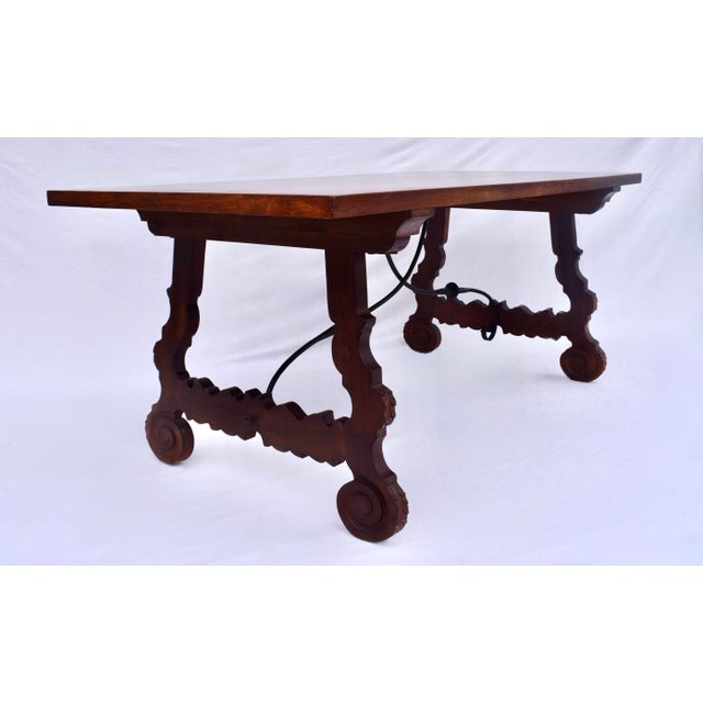 An impressive Spanish Colonial style dining table custom made in Spain with meticulous old world styling in the...