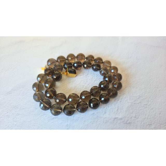 This is a magnificent vintage smoky quartz necklace that is sure to captivate. Large 16-17 mm faceted beads, strung on a...