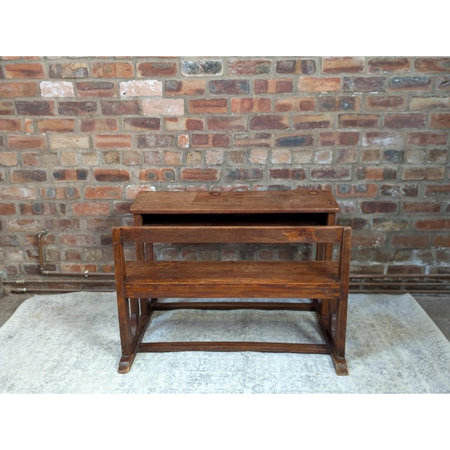 An authentic vintage double school desk crafted from oak, designed for two children with an integrated bench. Features...