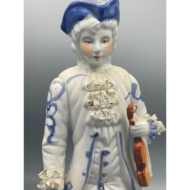 Charming vintage Italian porcelain figural pair featuring a gentleman and lady in beautifully detailed period dress. The...