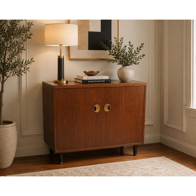 This elegant mid-century modern cabinet by Baker Furniture showcases the brand’s signature craftsmanship and refined...
