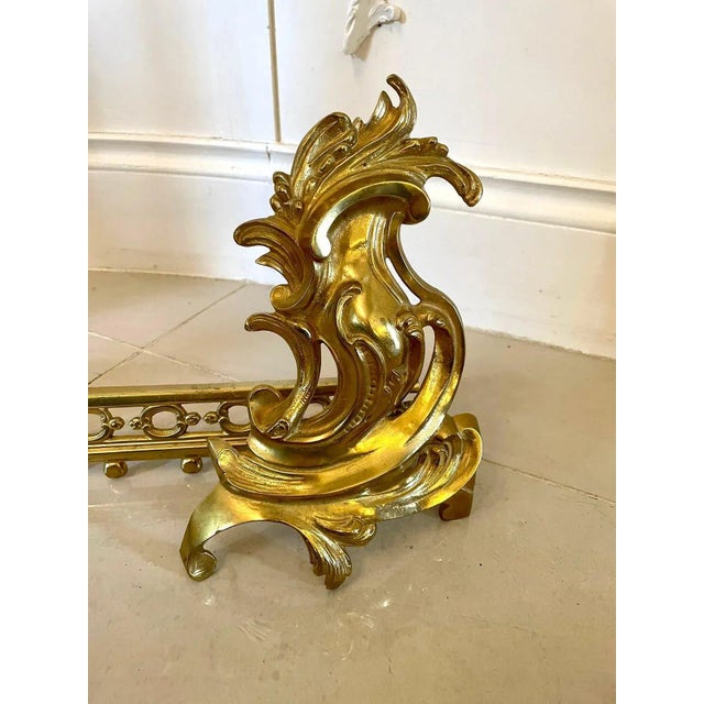 Fine quality french ornate gilded brass extending fender having stunning ornate gilded brass ends with scrolls and a...