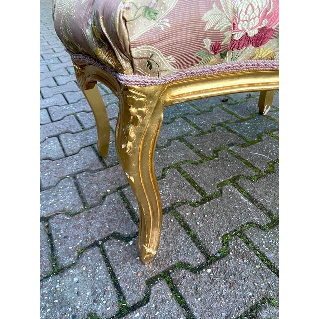 A graceful 1980s French Louis XVI-style bench, crafted from solid beechwood with a hand-gilded gold finish and newly...
