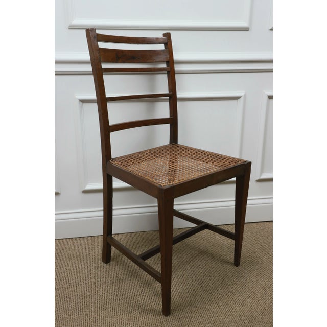 Pair of finely crafted Art Deco side chairs in Brazilian rosewood with hand caned seats and H-stretcher. France 1920....