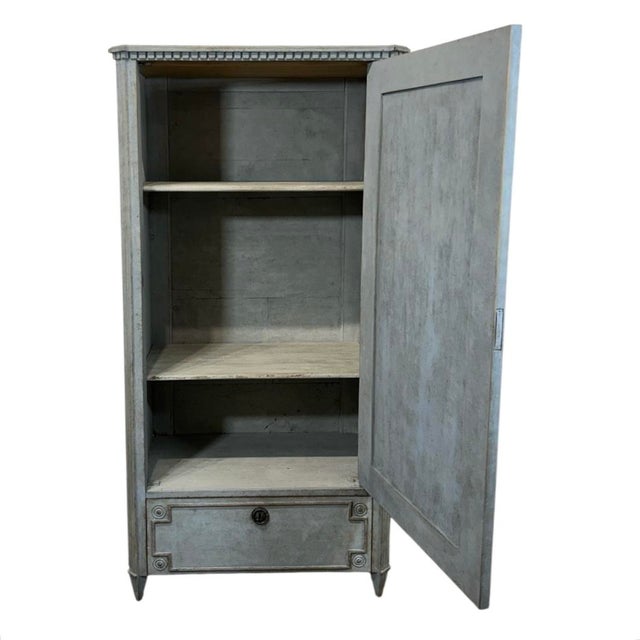 A mid 19th century Gustavian style wardrobe made in Sweden. A wonderful small size that can fit in any room for extra...