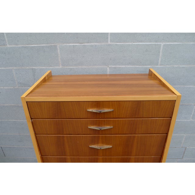 Drawer cabinet in asymmetrical design. The body is made of veneered solid wood. Walnut with great flaming, the edges in...