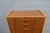 Drawer cabinet in asymmetrical design. The body is made of veneered solid wood. Walnut with great flaming, the edges in...