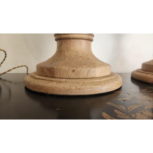 Handsome pair of vintage turned wood table lamps featuring solid-feeling wood urn-form bodies with beautiful natural...