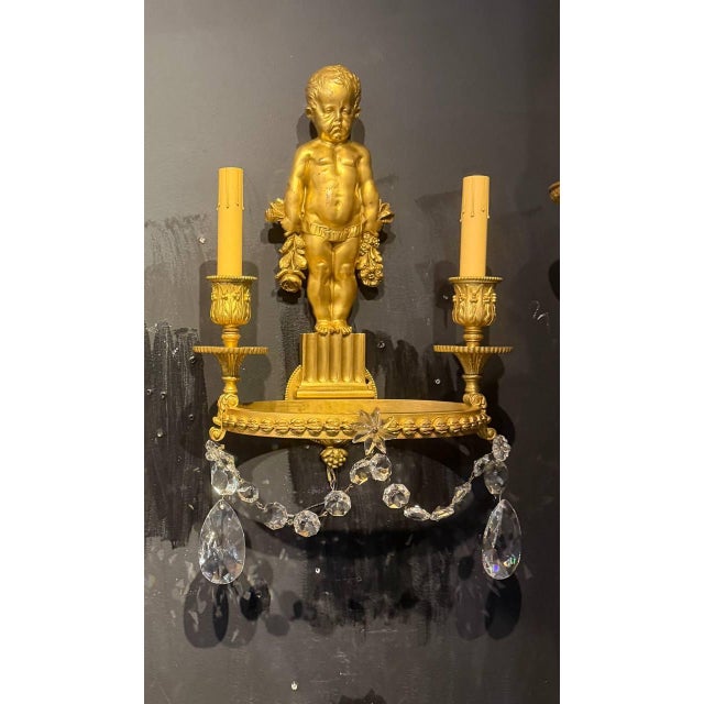 Pair of very unusual neoclassical Caldwell sconces with putti backplate and round arms