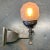 Unusual wall sconce from the gas era with a very unusual gas shade. Holes on shade vent the heat from the burning gas....