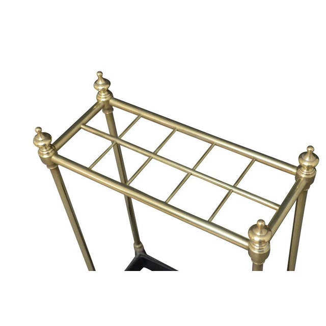 Late Victorian brass umbrella stand / stick stand, having ten sections for umbrellas and walking sticks with finials and...
