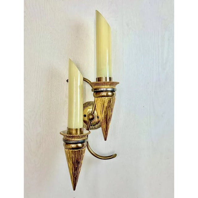Very charming and rare wall lamp of bronze and porcelain with glass "candles". Truly a 1950s item, typically Austrian....