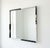 Striking postmodern square mirror featuring a bold black and white marble frame with contrasting corner details. The...