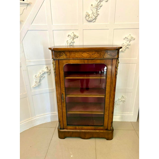 A very attractive antique Victorian inlaid walnut pier cabinet of elegant proportions and unusually tall height, making it...