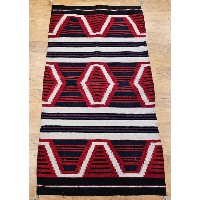 This vintage Native American Navajo rug, woven circa the mid-1900s, features the iconic Chief Blanket pattern, a bold and...