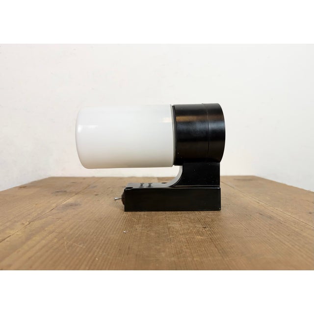 Vintage industrial dark brown bakelite wall lamp made by Elektrosvit in former Czechoslovakia during the 1960s. It...