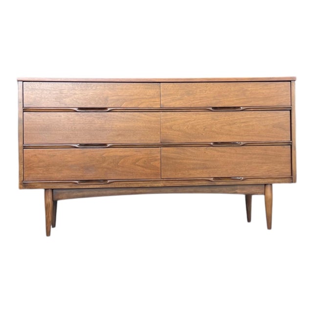This beautifully restored mid-century modern walnut lowboy dresser showcases the timeless simplicity and clean...