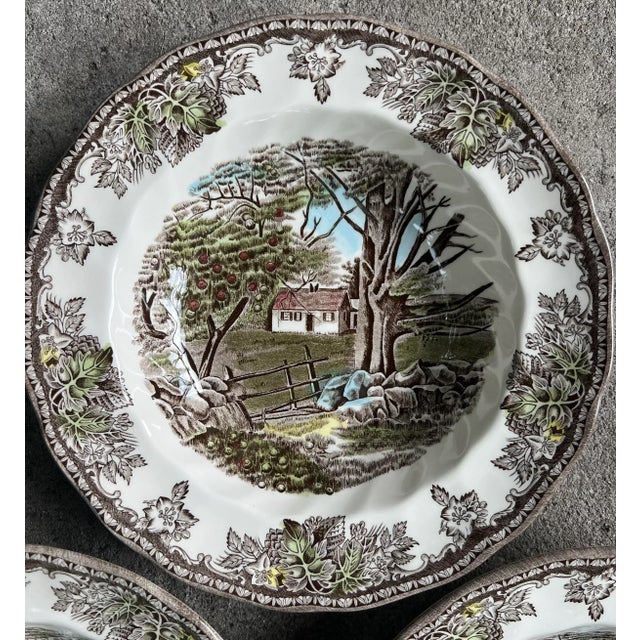 A set of three soup bowls with rim in traditional transferware- They each feature alike the "The Stone Wall" scene in the...