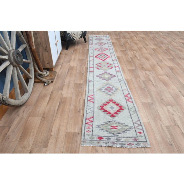 Vintage Turkish Hand-Knotted vintage rug is a semi-antique vintage runner rug. The '70s Eastern region of Turkey's unique...