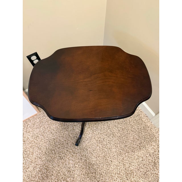Charming vintage mahogany occasional table with a scalloped pie-crust edge top in a distinctive rectangular shape. The...