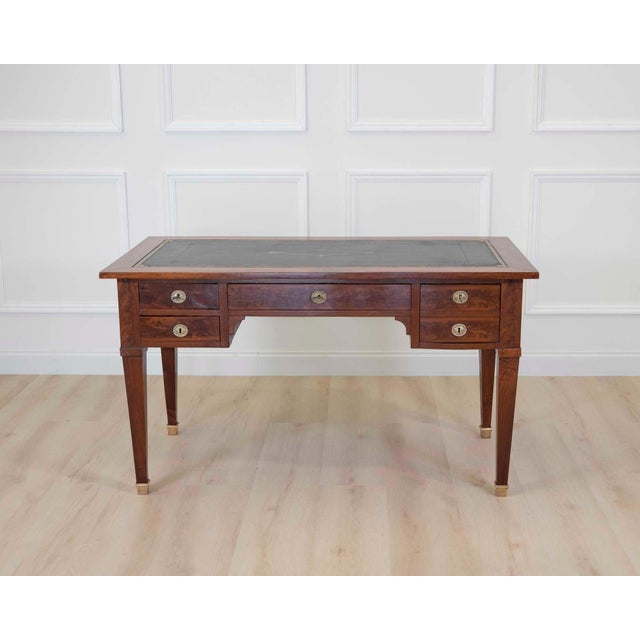 Made in France in the nineteenth century, this desk is worked in wood veneer in the Louis XVI taste. The front is fitted...