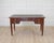Made in France in the nineteenth century, this desk is worked in wood veneer in the Louis XVI taste. The front is fitted...