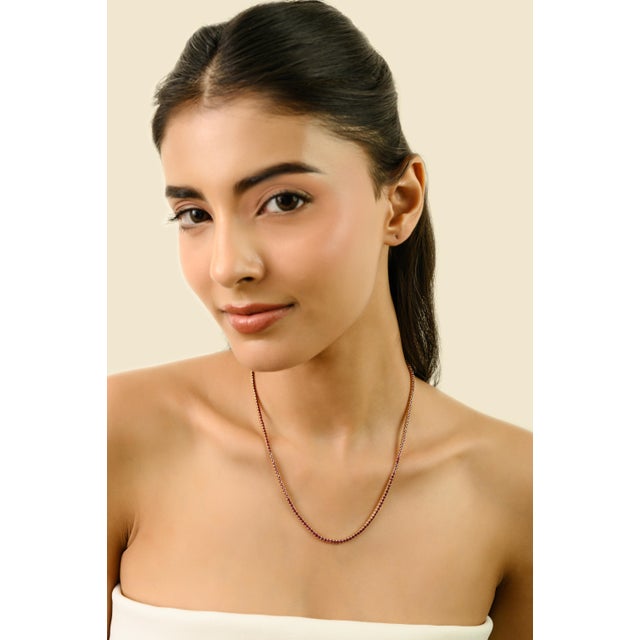 This modernist tennis necklace showcases round-cut rubies totaling 8.54 carats, elegantly set in luxurious 14K yellow...