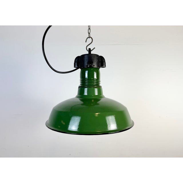 Industrial green enamel factory pendant light made in United States during the 1960s. White enamel inside the shade. Iron...
