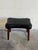 This minimalist ottoman features a gently contoured rectangular top raised on slender round legs. Its low profile offers...
