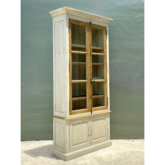 This impressive vintage tall cabinet embodies the timeless appeal of rustic craftsmanship with its beautifully distressed...