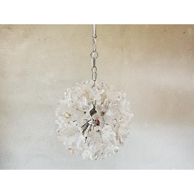 A beautiful design piece from italy. 1970s chrome sputnik lamp with 30 sculpted glass flowers. A design by paolo venini...