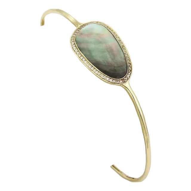 This lovely authentic bangle is by renowned designer Ippolita, it is crafted in solid 18k yellow gold with two pebble...