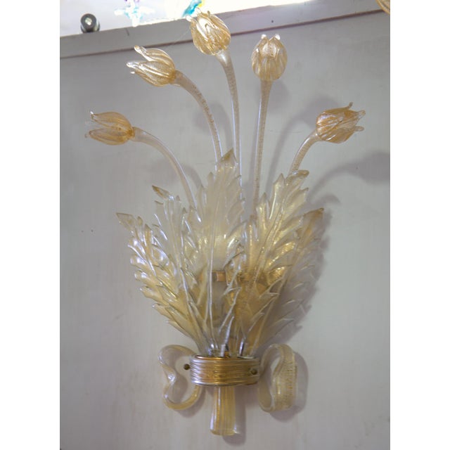 Pair of detailed and elaborate luxury appliques. The wall light has the hardware covered by a glass ribbon and houses 5...