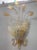 Pair of detailed and elaborate luxury appliques. The wall light has the hardware covered by a glass ribbon and houses 5...